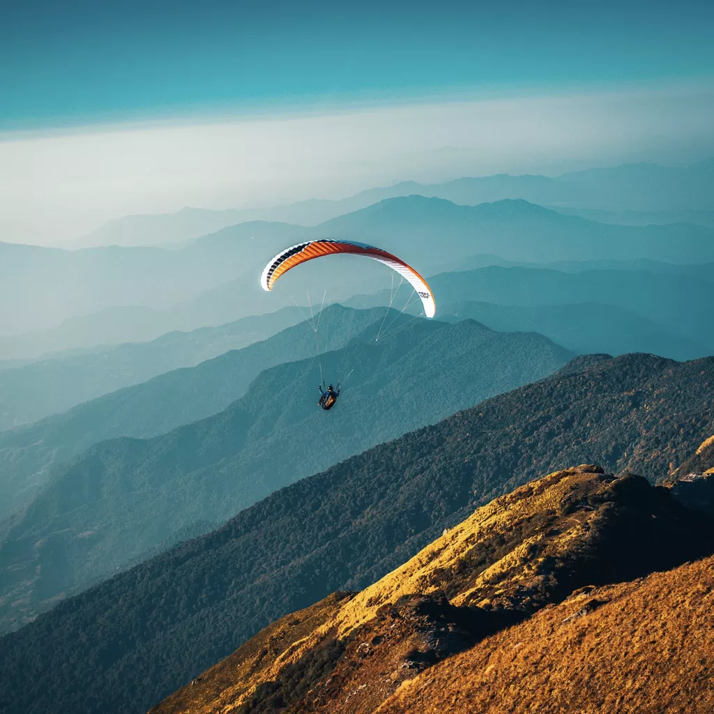 An aerial view of someone paragliding.