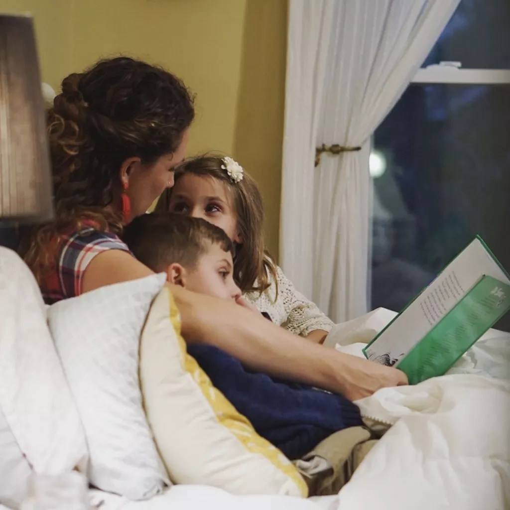 A mother reading to her children.