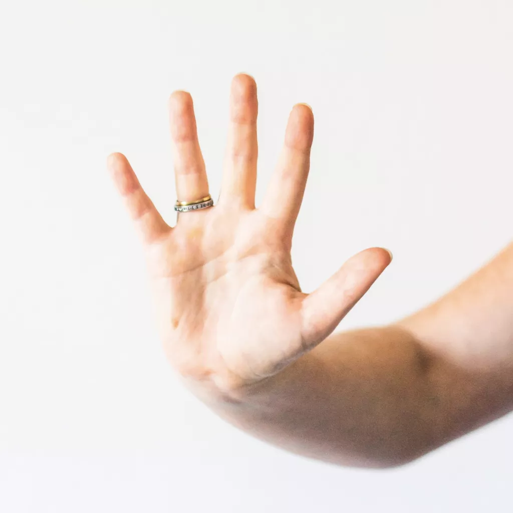 Hand holding up five fingers.
