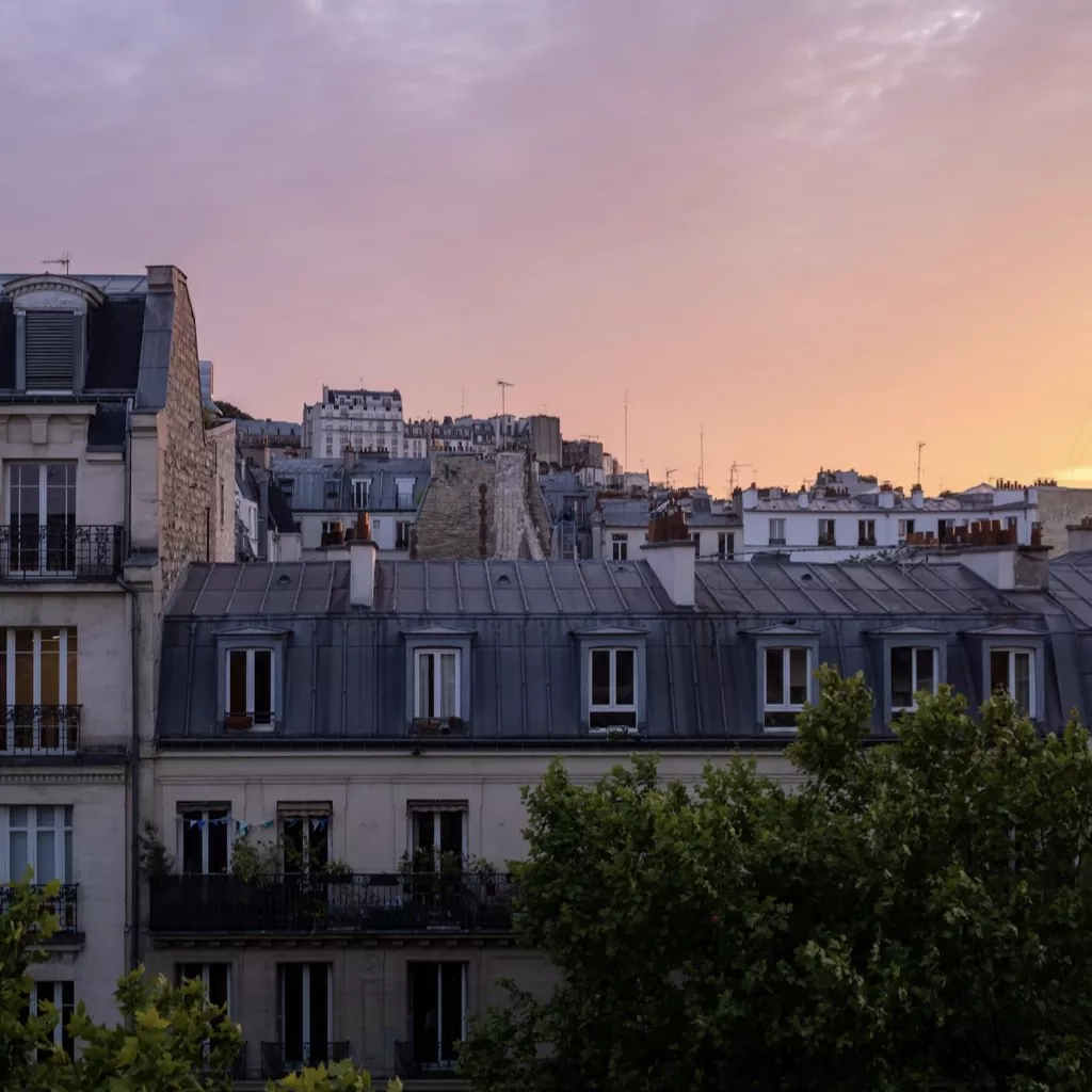 The view out of someone's house, as the sun sets.