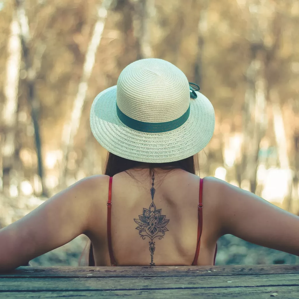 A lady's tattoo on her back.