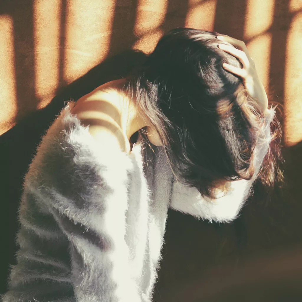 A lady looking in despair.