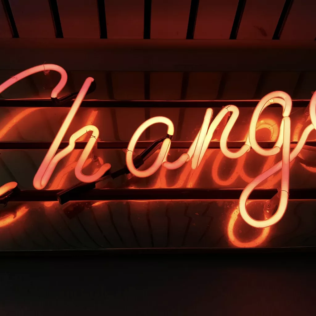 A colourful light spelling out 'change'.