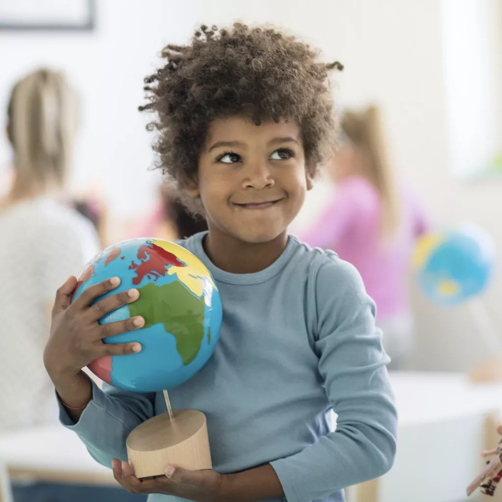 A child holding a globe.