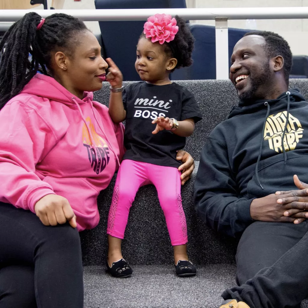 A young daughter stood between her two parents.