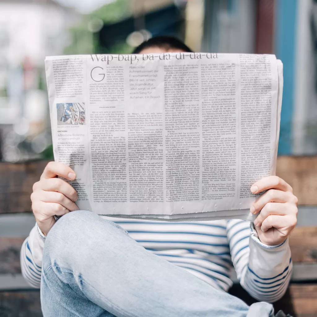 A man reading a newspaper.