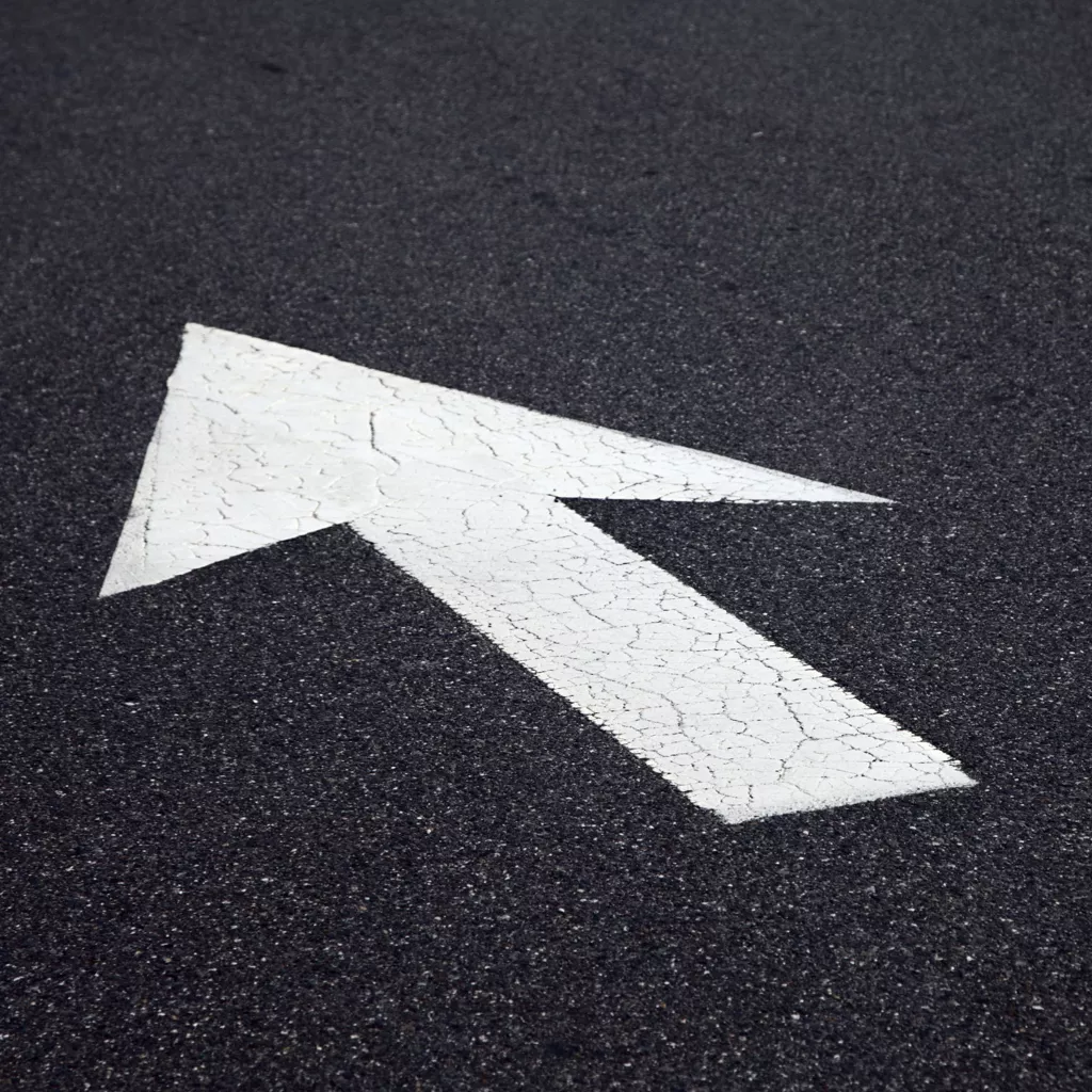 An arrow on the ground pointing to a different direction.