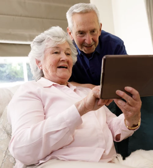 Grandparents reading a family story that was shared digitally
