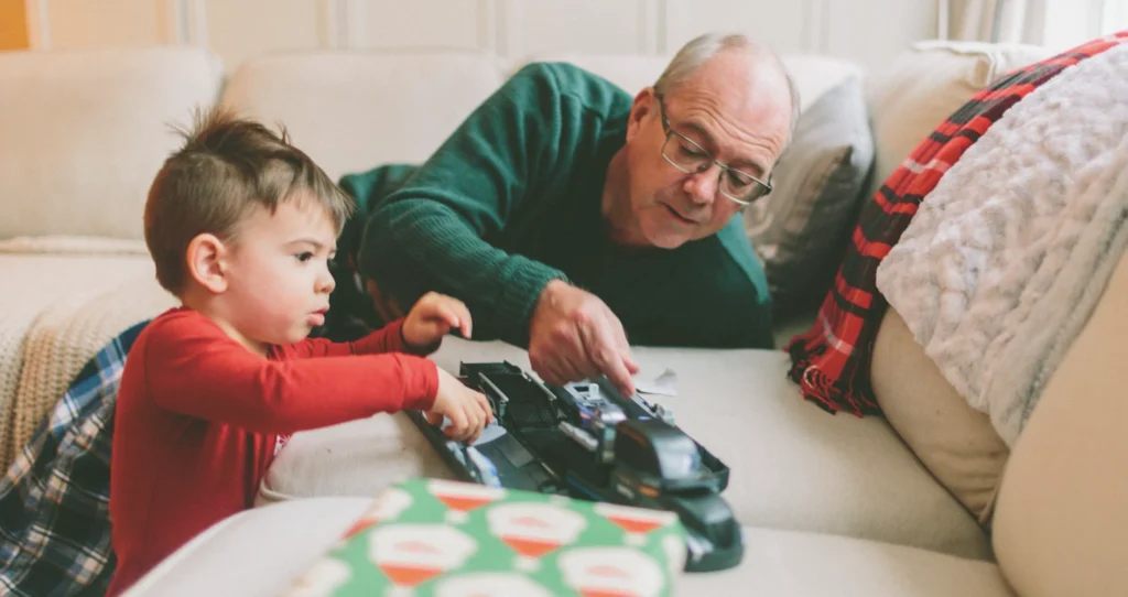 A grandfather playing with his grandson.