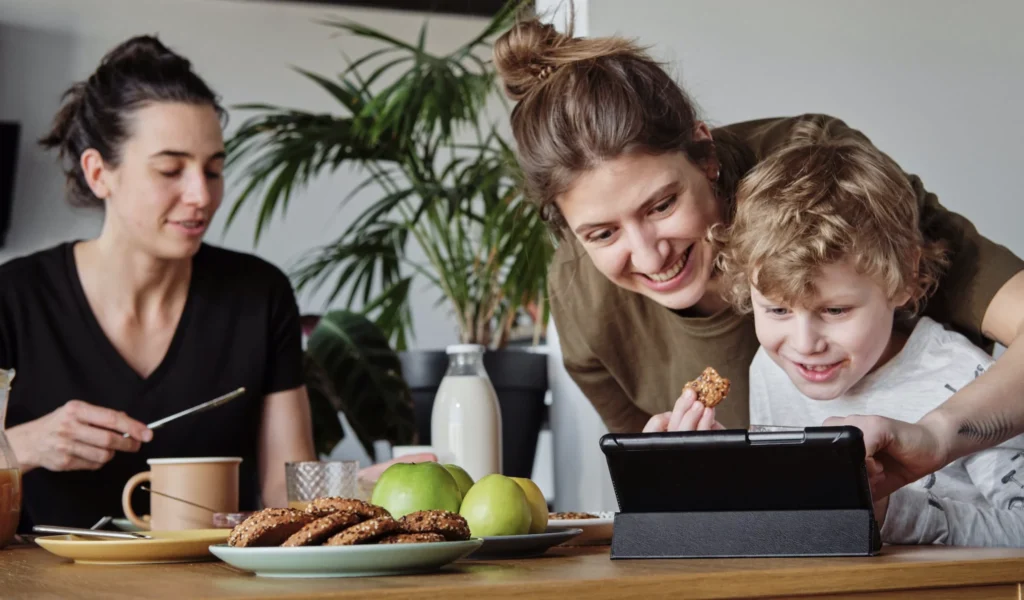 Digital storytelling in action as this family enjoy reading a story online.